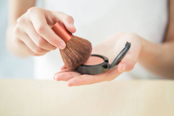 Applying blush with a brush